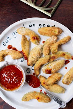 Crispy Baked Avocado Fries with Harissa Dipping sauce on a white plate