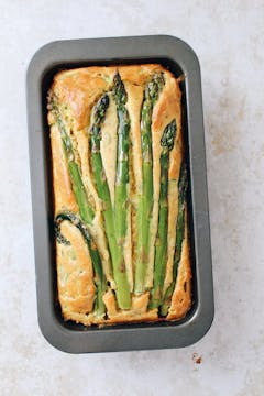 A baked asparagus loaf in a cake tin. 