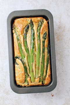 A baked asparagus loaf in a cake tin.