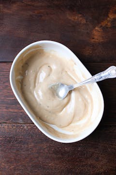 Tahini dressing in small bowl with spoon