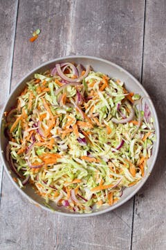 all the ingredients mixed for cabbage tahini coleslaw