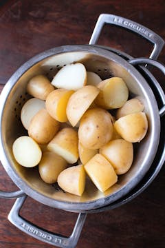 Cooked potatoes in sieve