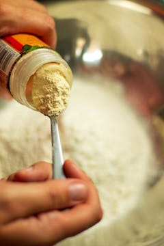 Garlic powder being added to the batter