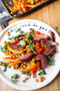 Mediterranean traybake with chickpeas and red onion on a white plate 