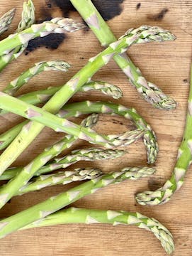 Asparagus spears on a wooden chopping board