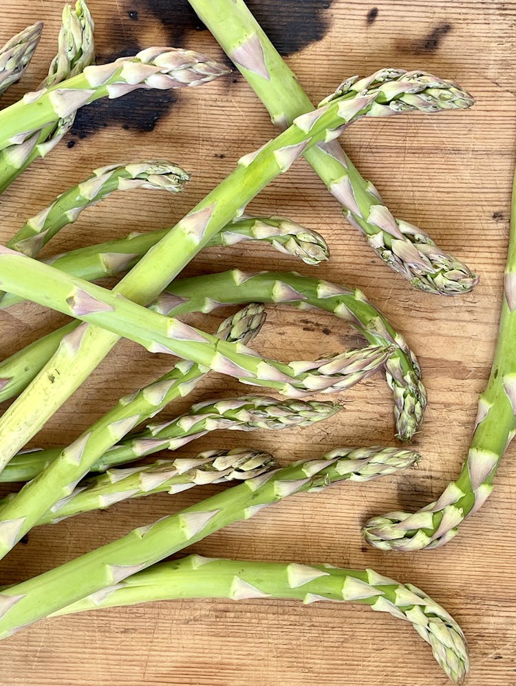 Asparagus spears on a wooden chopping board