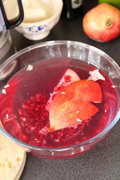 pomegranate being de-seeded