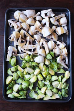 Raw brussels and mushrooms in baking tray