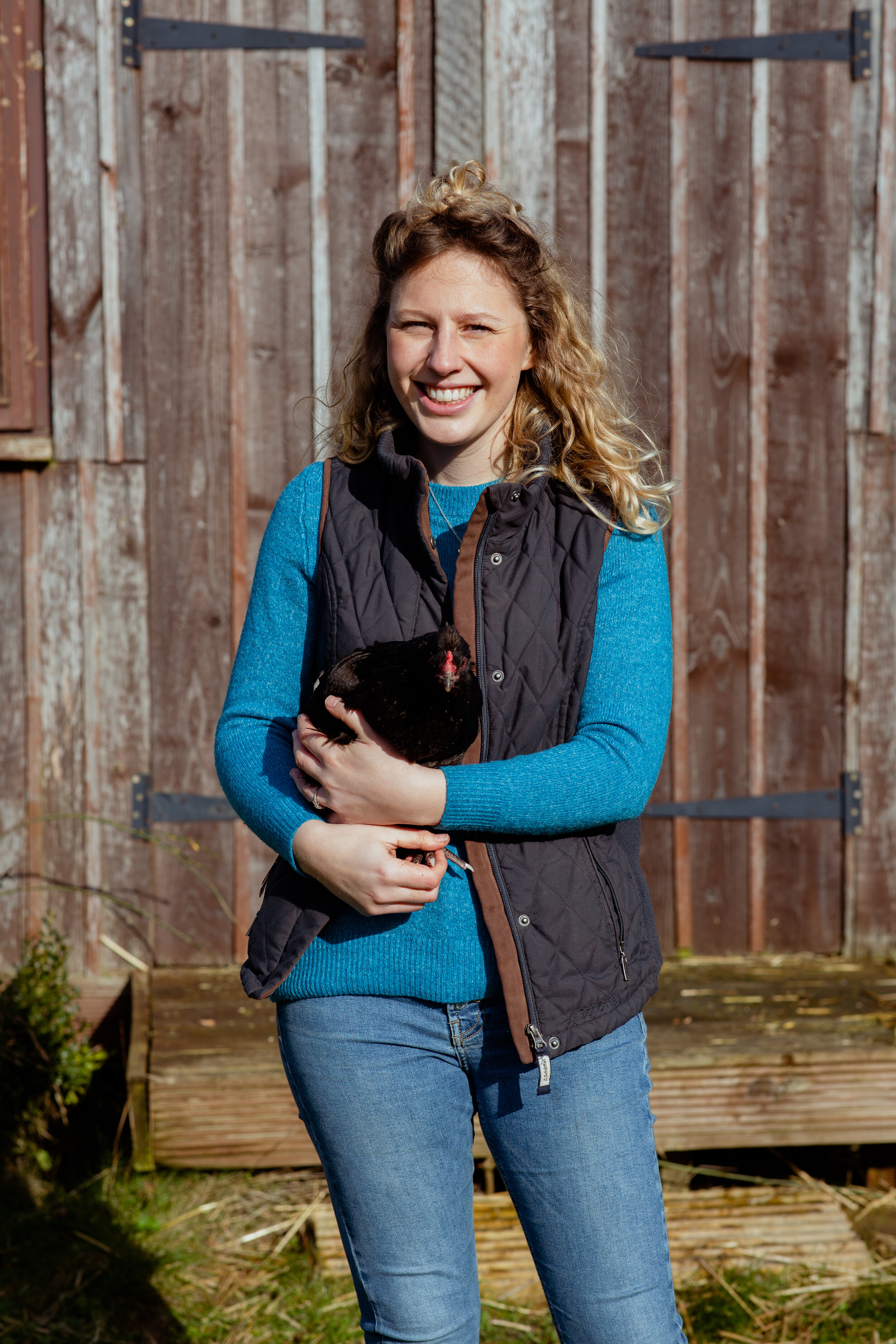 a farmer holding a hen