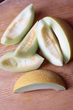 melon slices on chopping board 