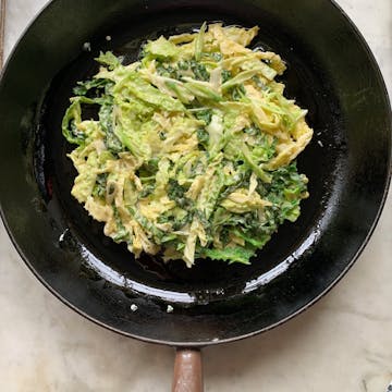savoy cabbage mixture on black frying pan 