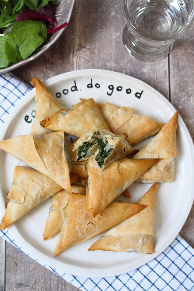 A plate with a pile of Spinach Filo Parcels.