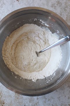 The ingredients for pizza dough starting to be incorporated. 