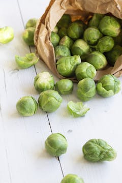 Brussels sprouts coming out of a paper bag