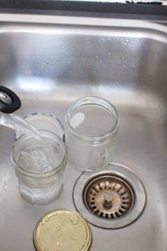 2 clear jar in the sink being cleaned 