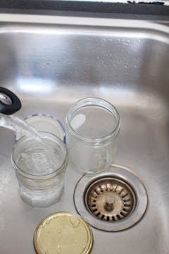 2 clear jar in the sink being cleaned