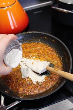 A roux made in a pan with vegan butter and spices. 