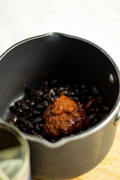 black beans and chipotle paste in a pan