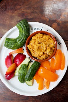 smokey butternut squash dip served with an assortment of cut up vegetables