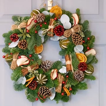 christmas wreath with pinecones on it