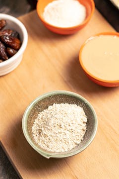 A bowl of oats blended into a rough flour.