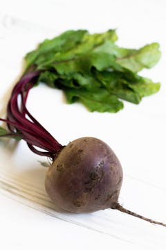 A whole beetroot on a worktop.