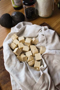 cubed tofu in tea towel 