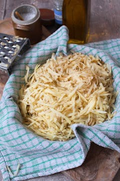bowl of grated potato in a clean towel