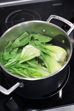 Pak Choi in a saucepan with water 