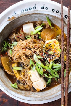 Zero-waste mushroom, ginger & garlic ramen in a white bowl with chopsticks