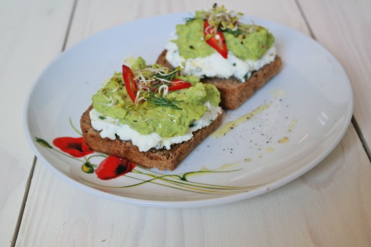 Two slices of summer broad bean bruschetta served on a plate. 