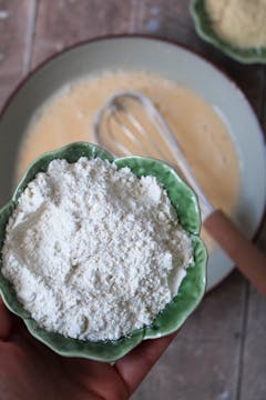 flour being added egg mixture