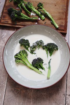 Sprouting broccoli in a bowl of batter. 