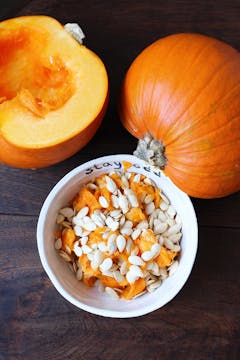 pumpkin cut in half and pumpkin seeds in oddbox bowl