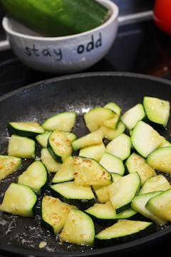 chopped courgette in a frying pan