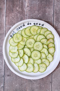 Thinly sliced cucumbers arranged on a plate. 
