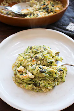 a spoon of green orzo on a plate