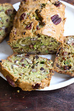 a loaf of courgette cake on a white plate