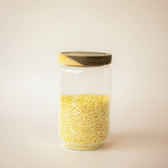 Glass jar filled with rice.