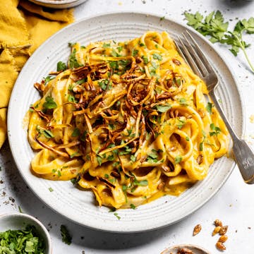 creamy butternut squash pasta with parsley and chilli flakes on top