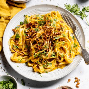 creamy butternut squash pasta with parsley and chilli flakes on top 