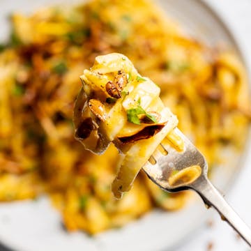 creamy butternut squash pasta on a fork 