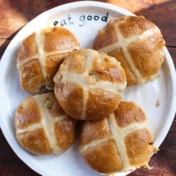 hot cross buns on a white plate 