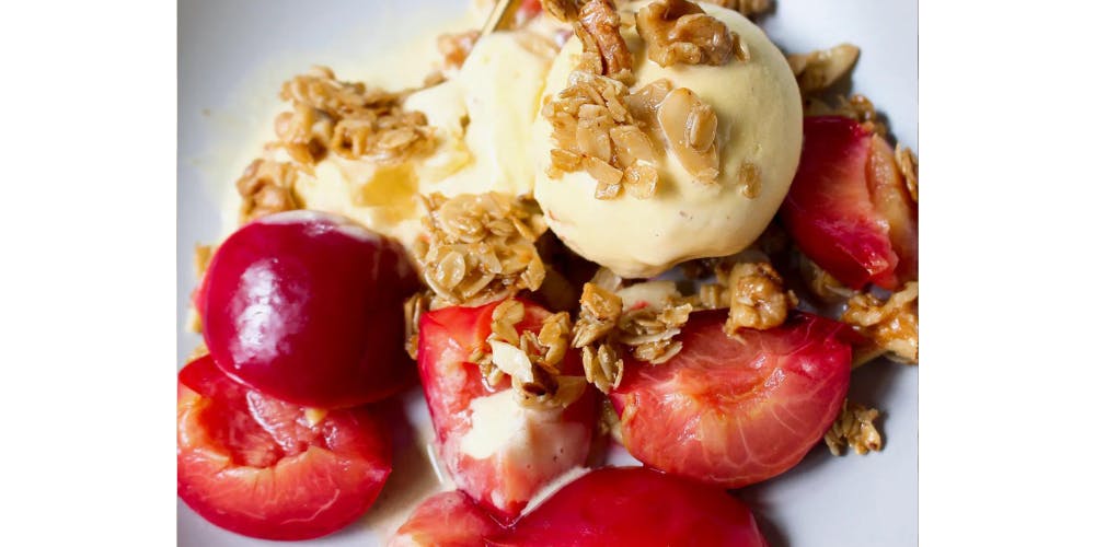 Poached plums topped with ice cream 