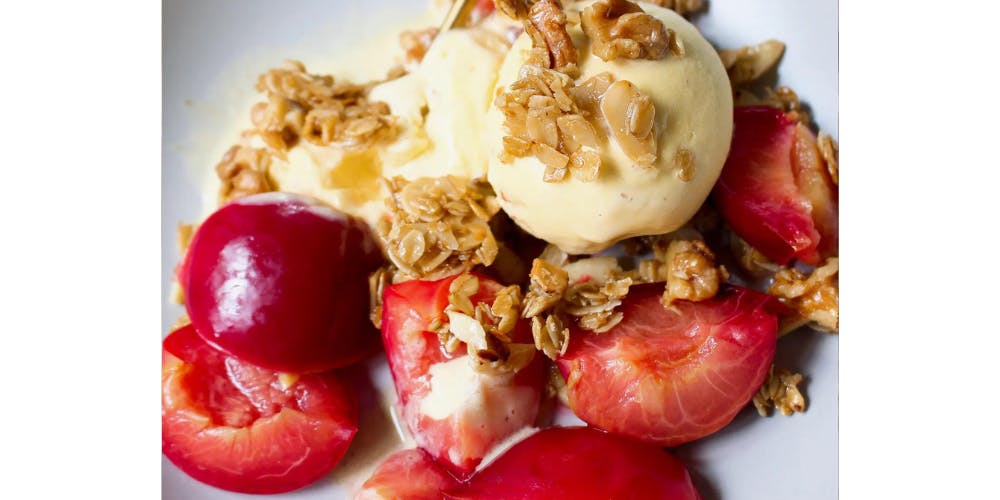 Poached plums topped with ice cream