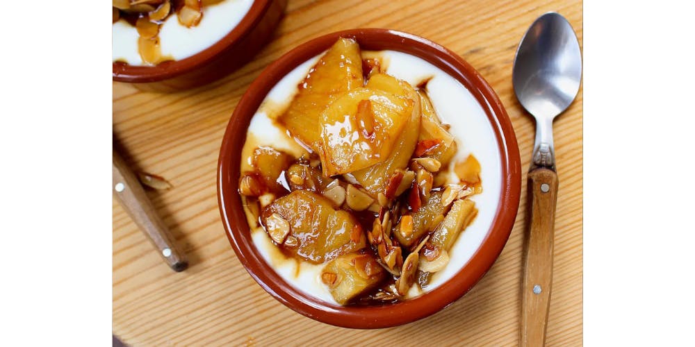 Caramelised pineapple over yoghurt with flaked almonds on top 