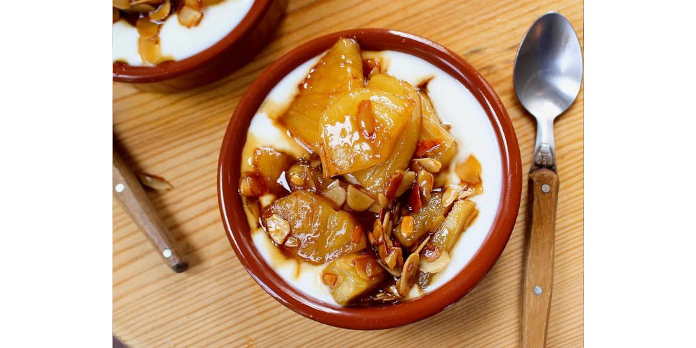 Caramelised pineapple over yoghurt with flaked almonds on top