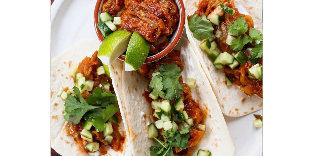 Aubergine fajitas with an aubergine dip and lime wedges