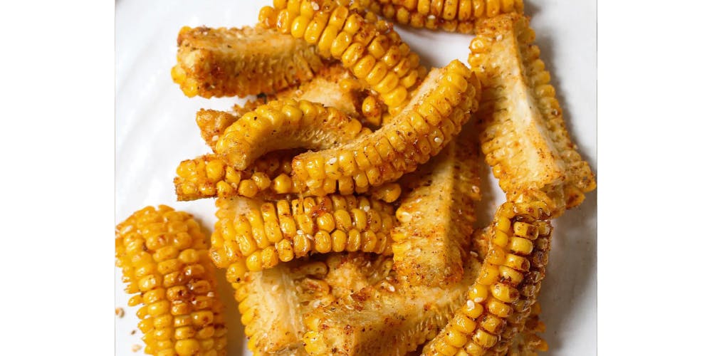 Spicy corn ribs on a white plate