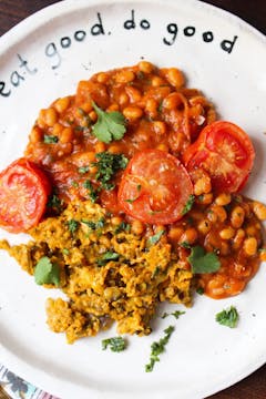 tomato akuri with scrambled tofu on a white plate